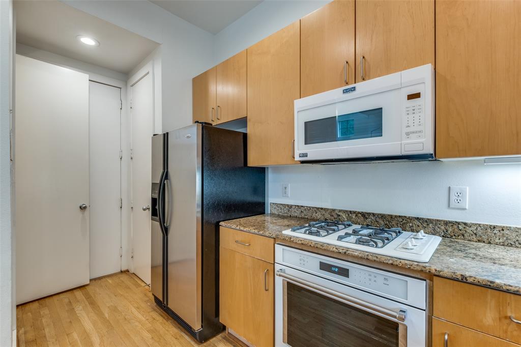 4302 Gilbert Avenue Dallas, TX 75219 - Photo 15 of 28 a kitchen with stainless steel appliances granite countertop cabinets and microwave