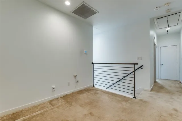 a view of a room with stairs and white walls