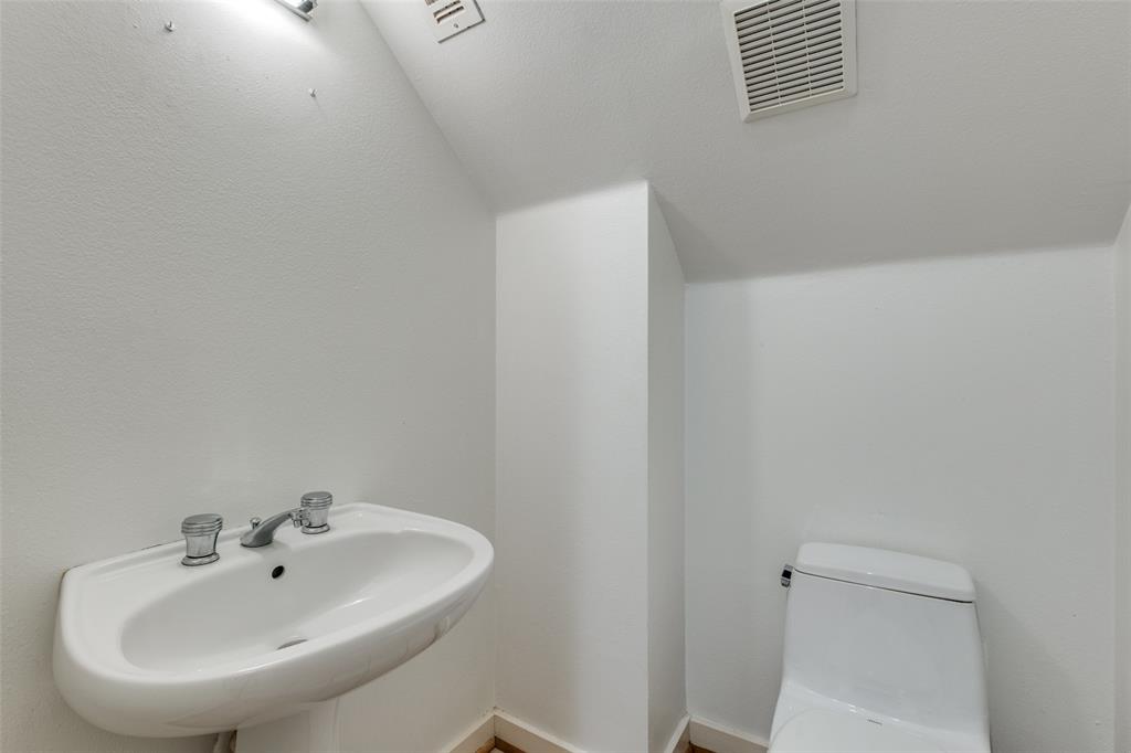 4302 Gilbert Avenue Dallas, TX 75219 - Photo 17 of 28 a bathroom with a sink and a mirror