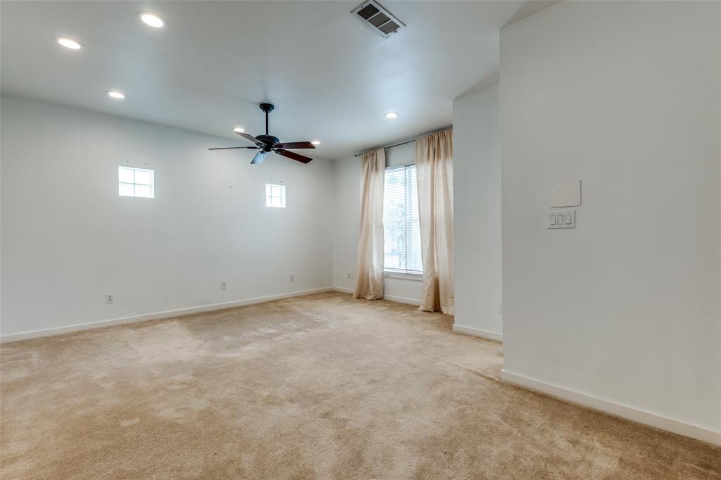 4302 Gilbert Avenue Dallas, TX 75219 - Photo 18 of 28 an empty room with a ceiling fan and carpet