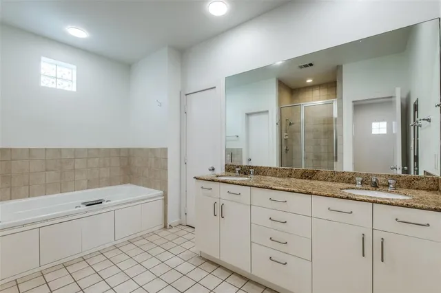 a bathroom with a granite countertop sink mirror and bathtub