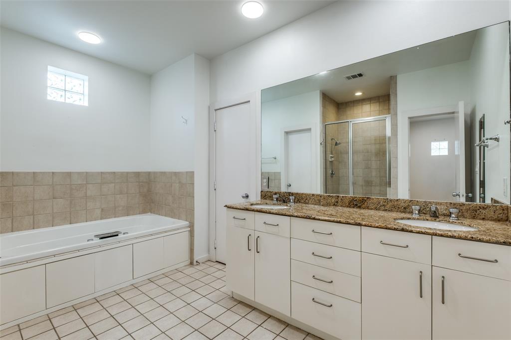 4302 Gilbert Avenue Dallas, TX 75219 - Photo 19 of 28 a bathroom with a granite countertop sink mirror and bathtub