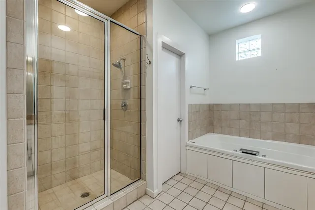 a bathroom with a bathtub and a shower