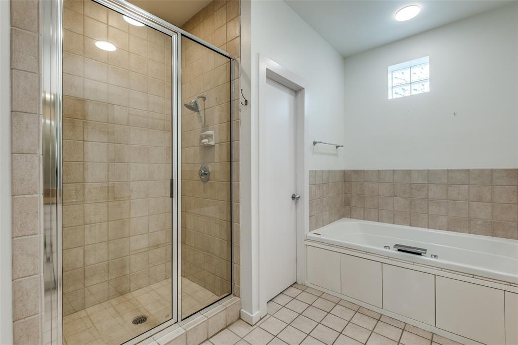 4302 Gilbert Avenue Dallas, TX 75219 - Photo 20 of 28 a bathroom with a bathtub and a shower