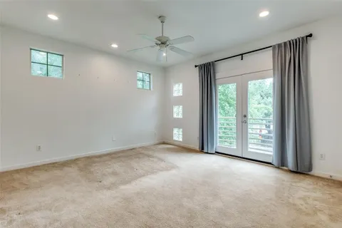 an empty room with windows and closet