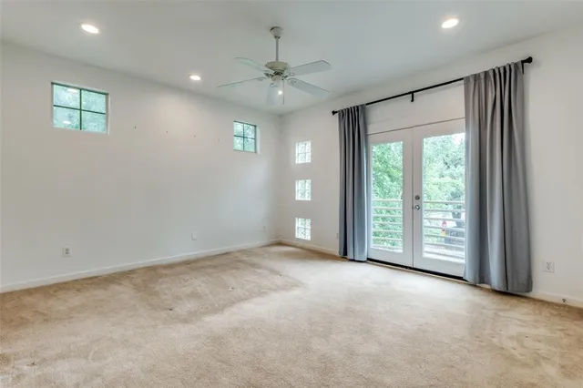 an empty room with windows and closet