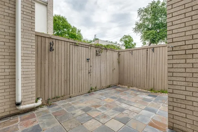 a view of backyard with wooden fence
