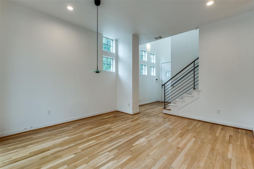 4302 Gilbert Avenue Dallas, TX 75219 - Photo 4 of 28 a view of an empty room with wooden floor and stairs