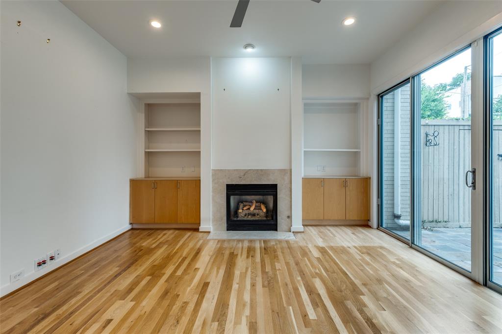 4302 Gilbert Avenue Dallas, TX 75219 - Photo 8 of 28 a view of a livingroom with a fireplace and window