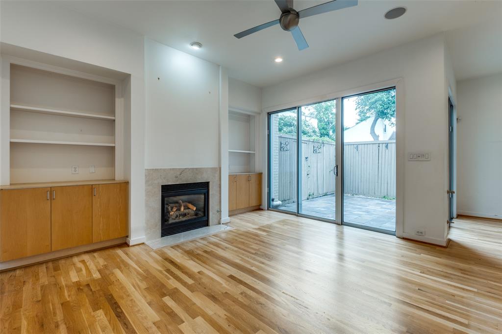 4302 Gilbert Avenue Dallas, TX 75219 - Photo 9 of 28 a view of an empty room with a fireplace and a window