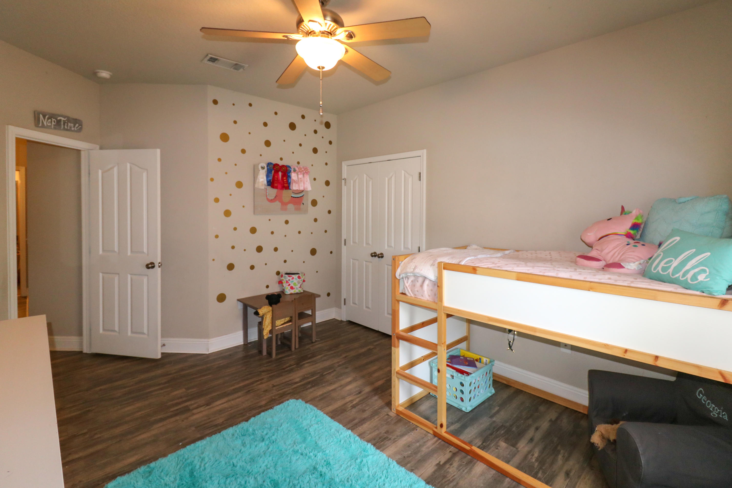 675 Red Fern Road Crestview, FL 32536 - Photo 21 of 35 a bedroom with a bed and wooden floor