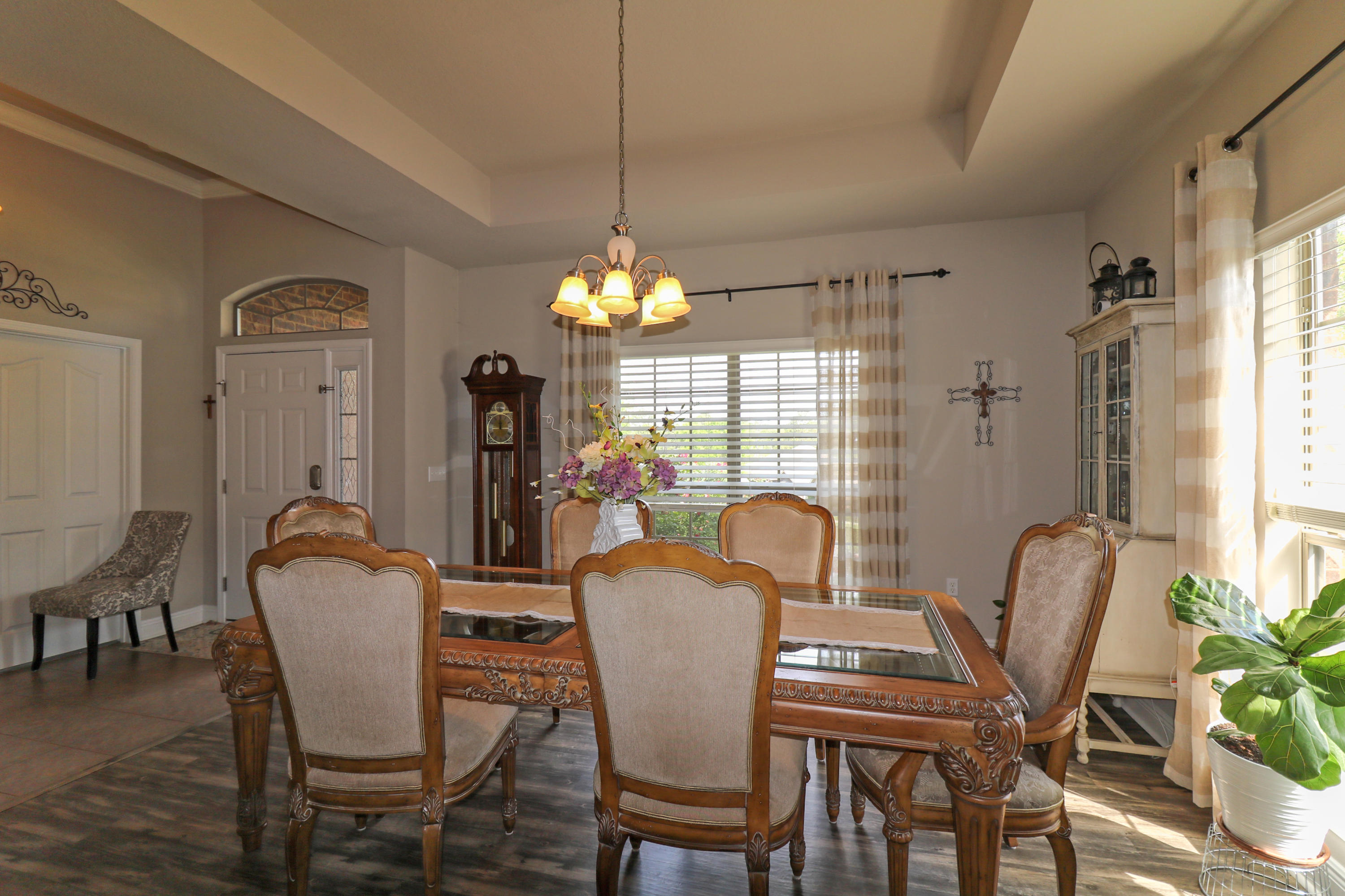 675 Red Fern Road Crestview, FL 32536 - Photo 7 of 35 a dining room with furniture a chandelier and wooden floor