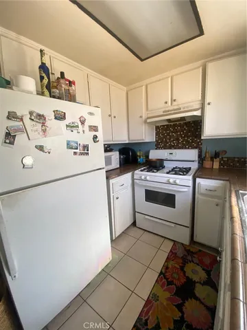 a white refrigerator freezer sitting inside of a kitchen