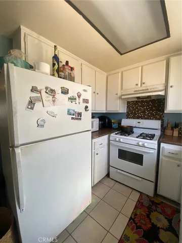 a white refrigerator freezer sitting inside of a kitchen