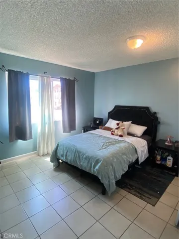 a spacious bedroom with a bed and a window