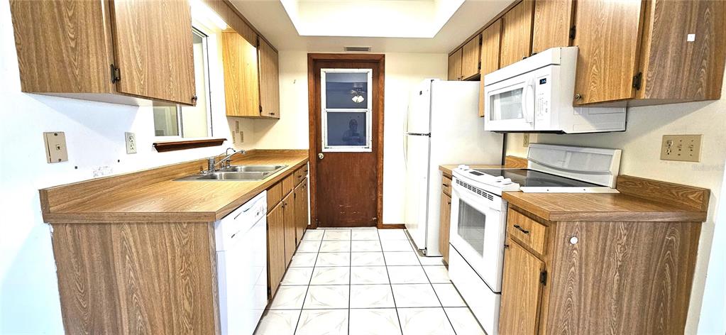 10838 Southwest 78th Court Ocala, FL 34476 - Photo 7 of 32 a kitchen with a sink a stove and a refrigerator
