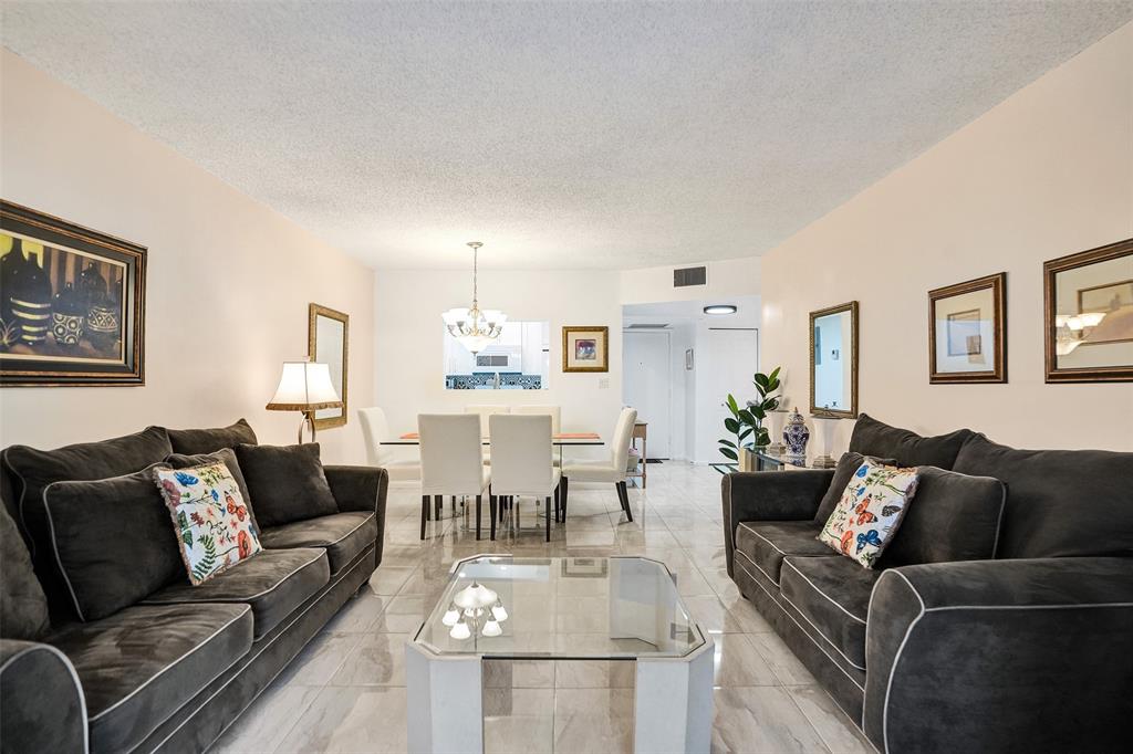 5681 Southwest 2nd Court, Unit 205 Margate, FL 33068 - Photo 11 of 37 a living room with furniture and a couch