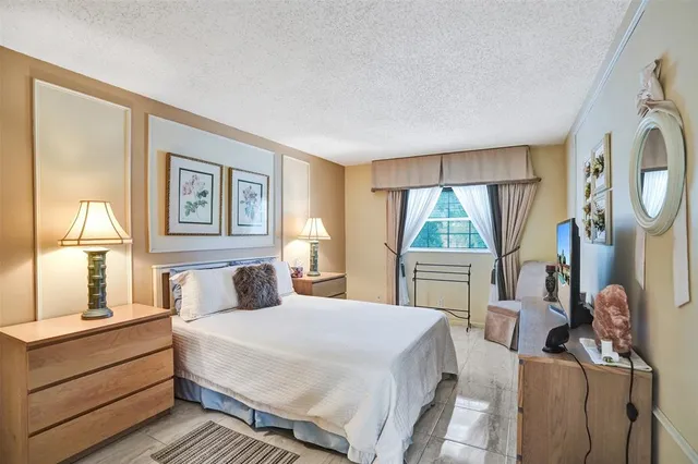 a bedroom with a bed and a large window with outer view