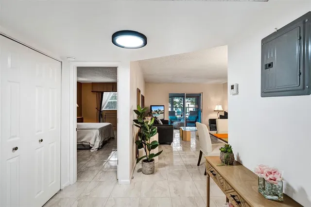 a view of a livingroom with lounge chair and a ceiling fan
