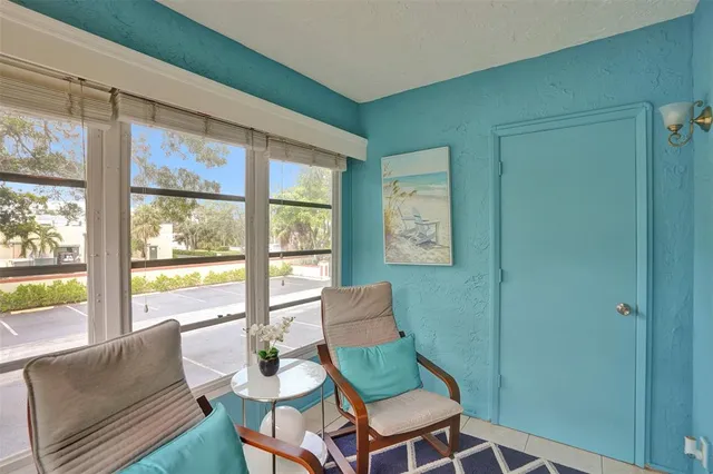 a living room with a large window and a table