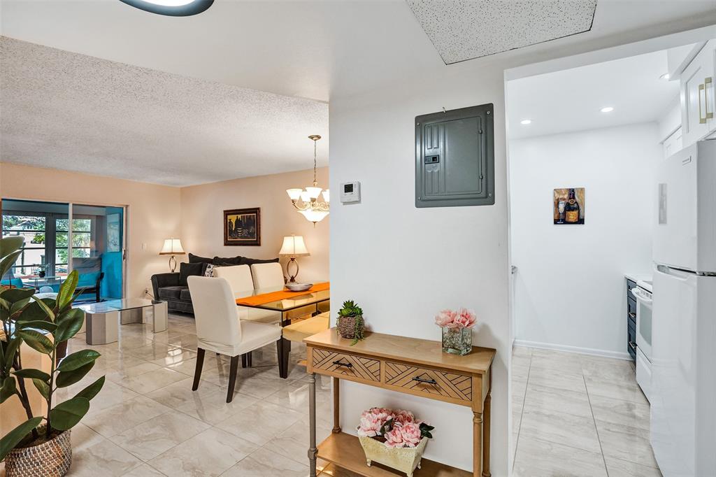 5681 Southwest 2nd Court, Unit 205 Margate, FL 33068 - Photo 19 of 37 a living room with furniture and a gate