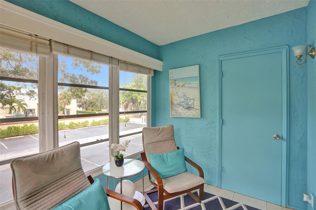 5681 Southwest 2nd Court, Unit 205 Margate, FL 33068 - Photo 21 of 37 a living room with a large window and a table