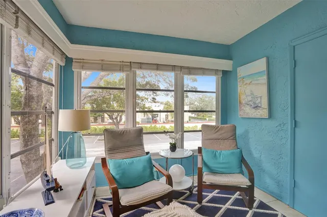 a living room with furniture and a floor to ceiling window