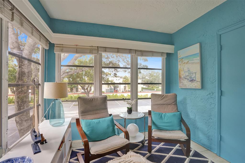 5681 Southwest 2nd Court, Unit 205 Margate, FL 33068 - Photo 22 of 37 a living room with furniture and a floor to ceiling window