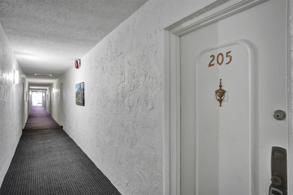 5681 Southwest 2nd Court, Unit 205 Margate, FL 33068 - Photo 24 of 37 a view of a hallway with wooden floor