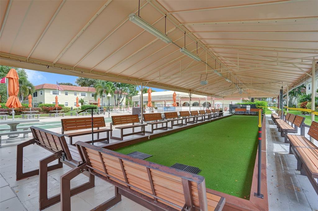 5681 Southwest 2nd Court, Unit 205 Margate, FL 33068 - Photo 28 of 37 a view of a patio with a table chairs and a backyard