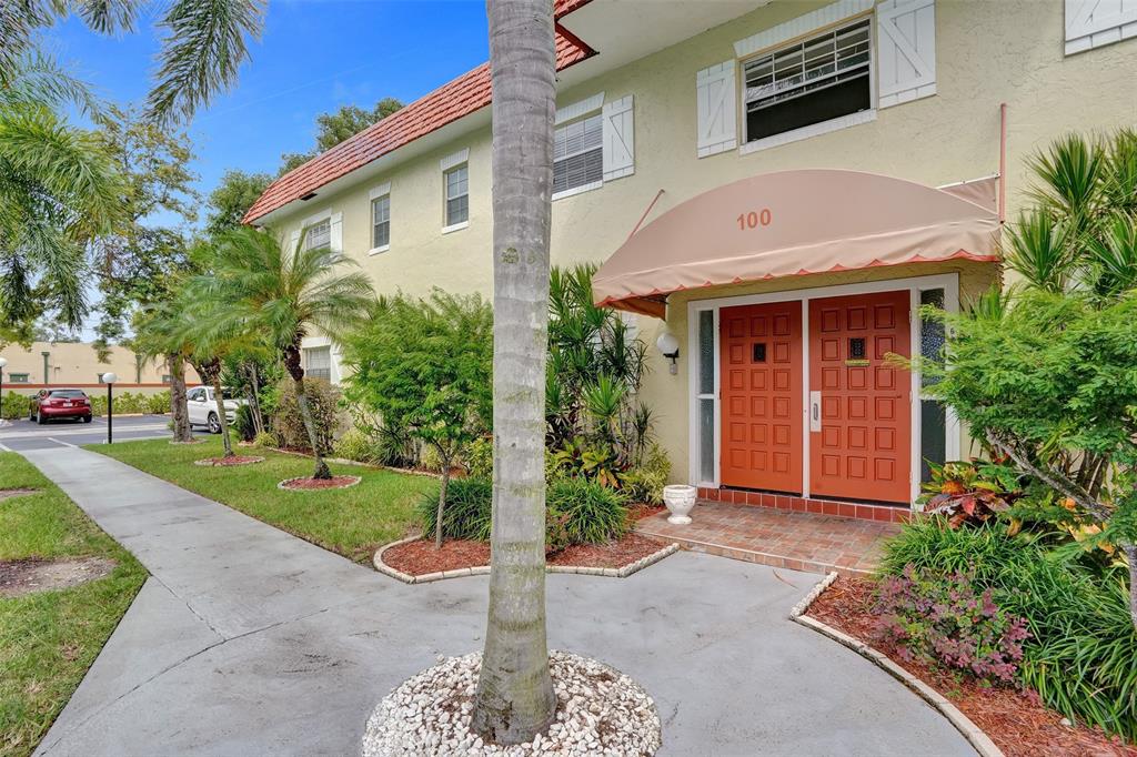5681 Southwest 2nd Court, Unit 205 Margate, FL 33068 - Photo 30 of 37 a front view of a house with garden