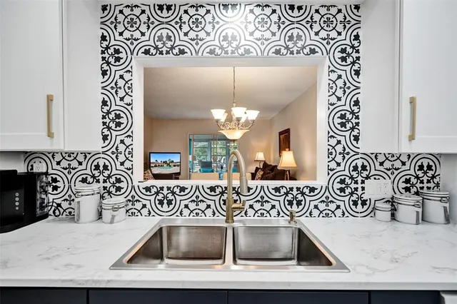 a view of a kitchen sink and microwave