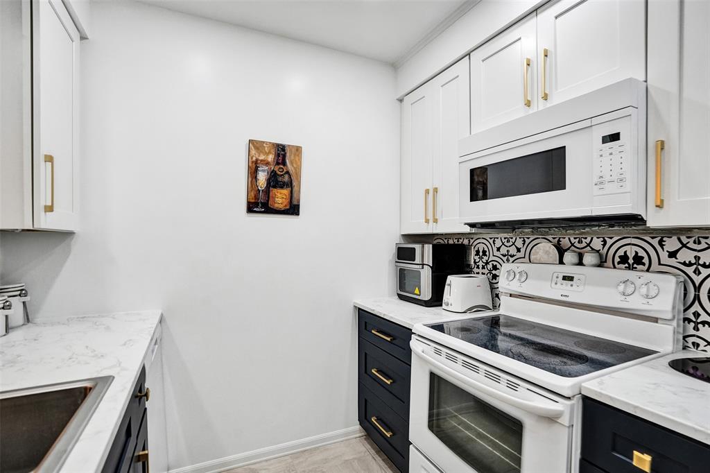 5681 Southwest 2nd Court, Unit 205 Margate, FL 33068 - Photo 7 of 37 a kitchen with a stove and a microwave