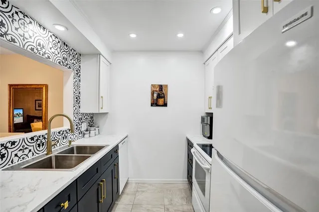 a kitchen with a sink stove and refrigerator