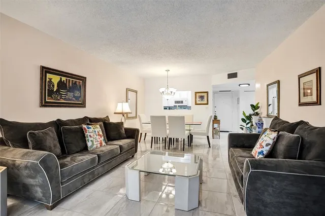 a living room with furniture potted plant and a window