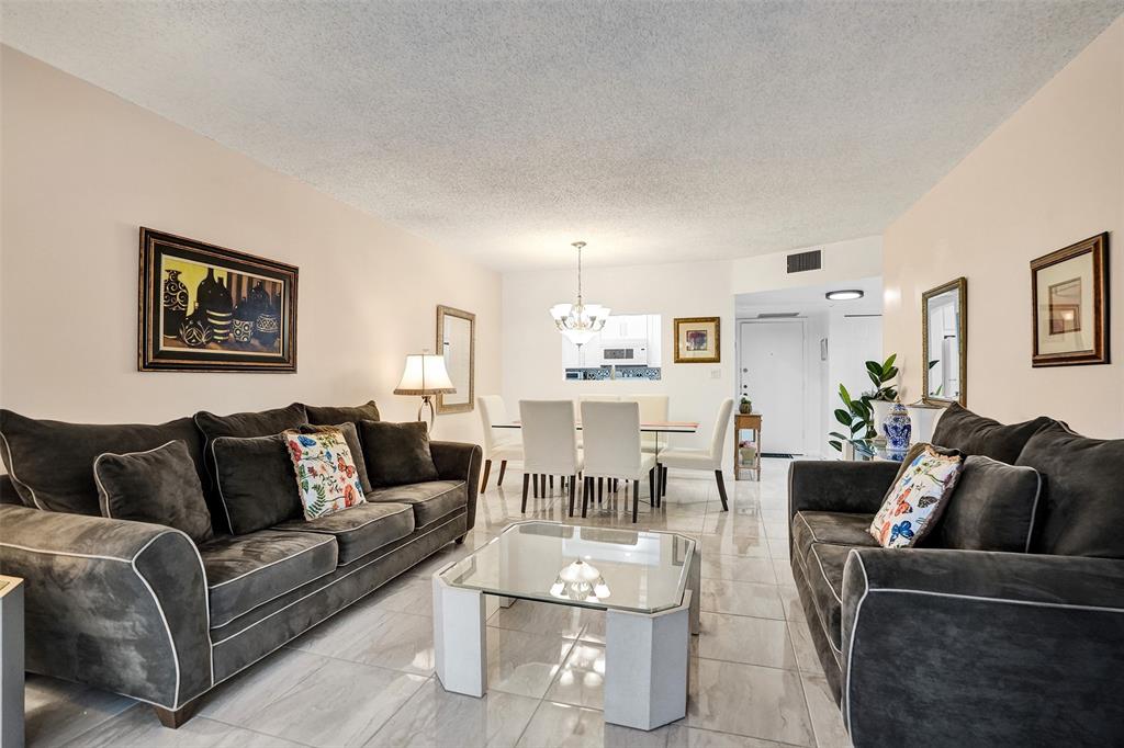 5681 Southwest 2nd Court, Unit 205 Margate, FL 33068 - Photo 10 of 37 a living room with furniture potted plant and a window