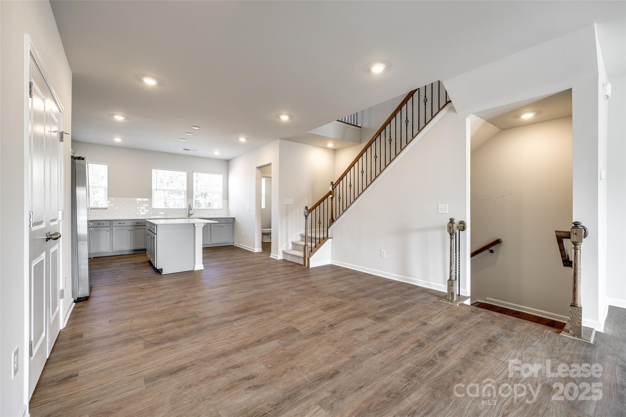 143 Morning Gap Parkway, Unit 14 Fort Mill, SC 29715 - Photo 12 of 30 an empty room with wooden floor and windows