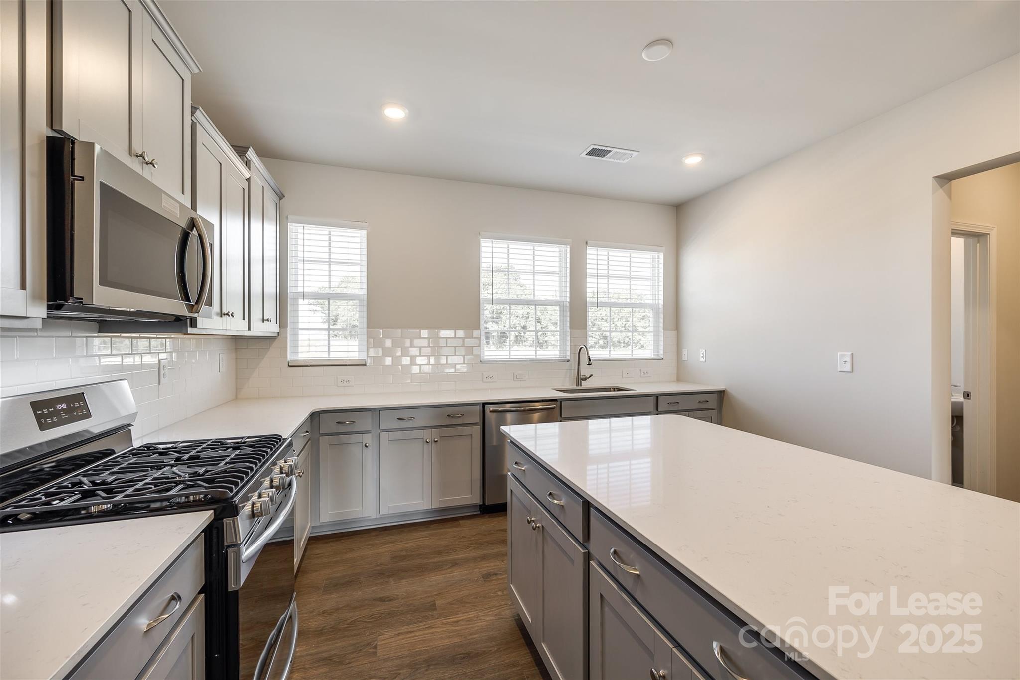 143 Morning Gap Parkway, Unit 14 Fort Mill, SC 29715 - Photo 14 of 30 a kitchen with stainless steel appliances granite countertop a sink stove and refrigerator