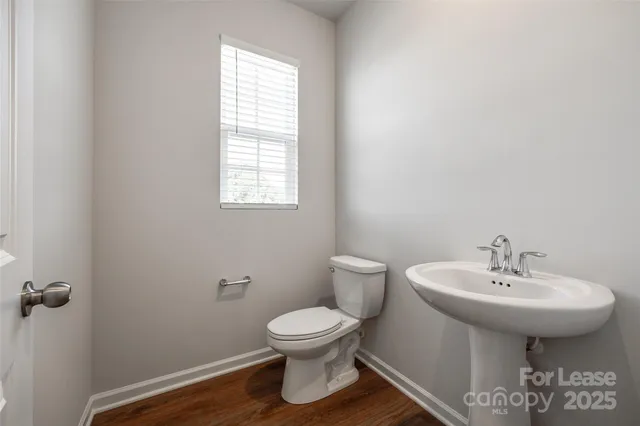a bathroom with a sink toilet and a mirror