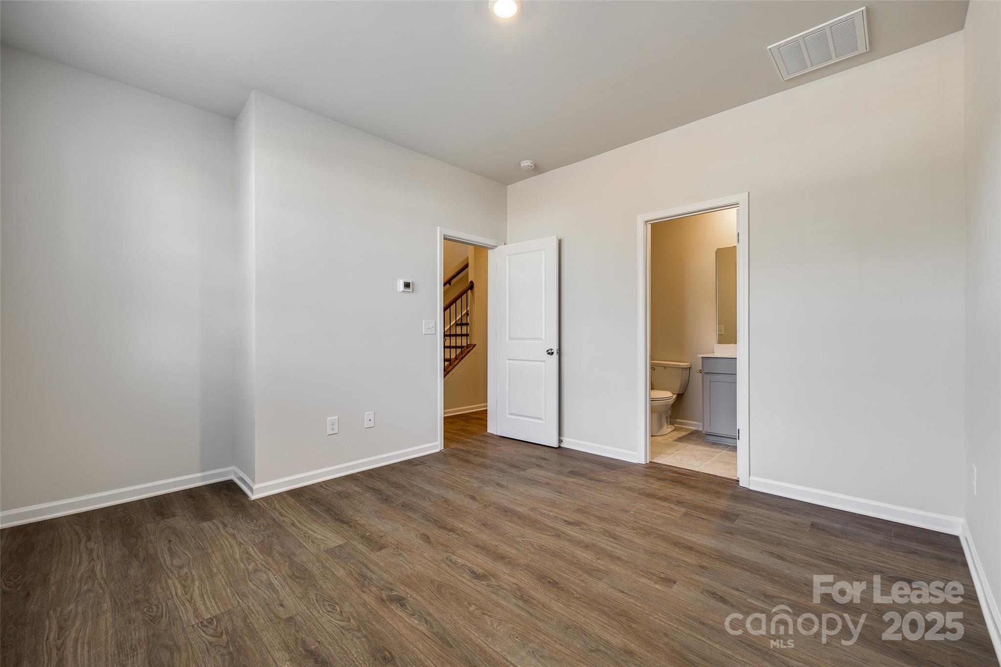 143 Morning Gap Parkway, Unit 14 Fort Mill, SC 29715 - Photo 6 of 30 a view of an empty room with wooden floor and closet