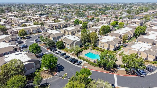 a sign of golf club on a wall under a tree
