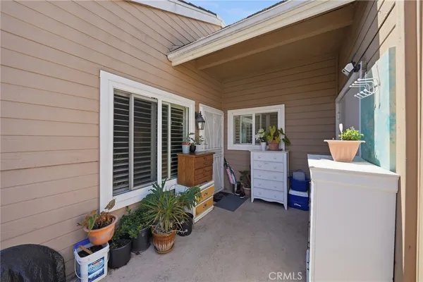 a living room with furniture a flat screen tv and a large window