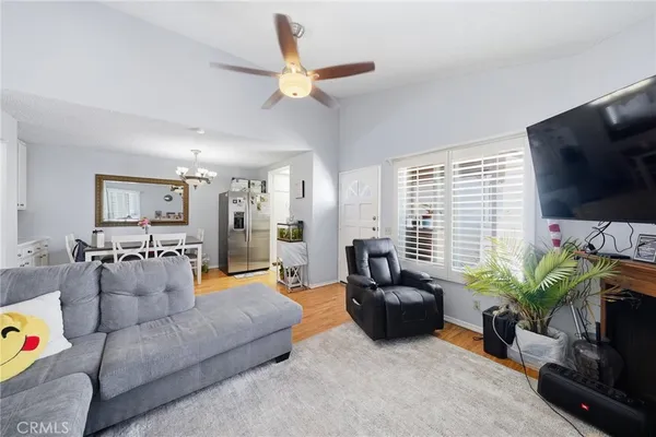 a view of a dining room with furniture and a chandelier