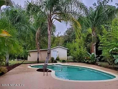 543 Ray Edwards Road St. Augustine, FL 32086 - Photo 18 of 19 a house with swimming pool in front of it