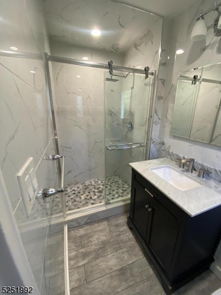 806 Morris Turnpike, Unit 2A8 Short Hills, NJ 07078 - Photo 10 of 13 a bathroom with a sink shower and a mirror