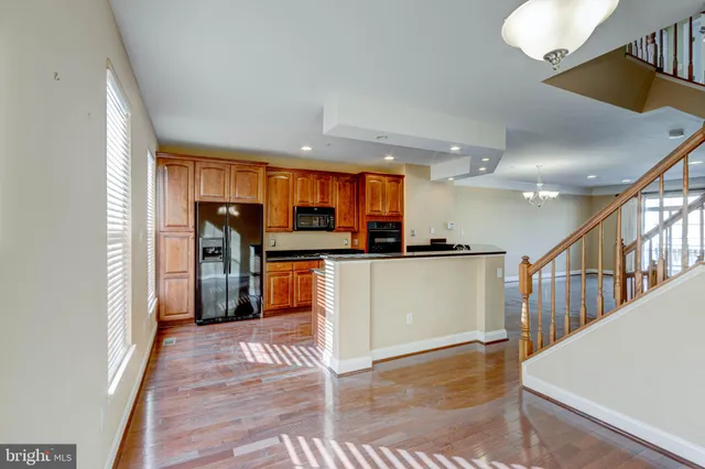 an empty room with wooden floor and fireplace