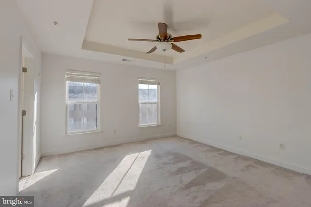 a view of kitchen with stainless steel appliances a refrigerator and wooden floor
