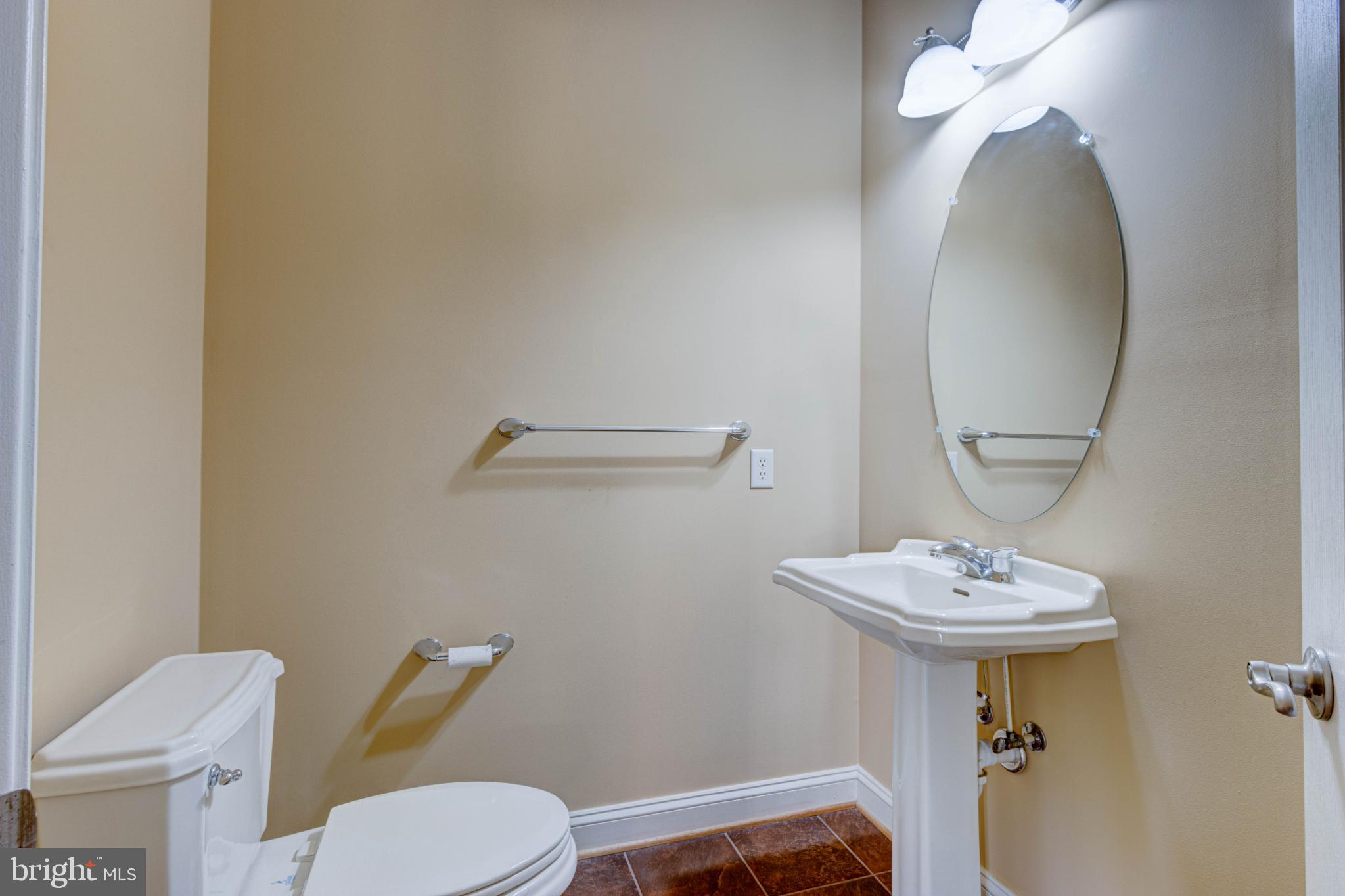 2629 Raptor Drive Odenton, MD 21113 - Photo 4 of 20 a bathroom with a toilet sink and mirror
