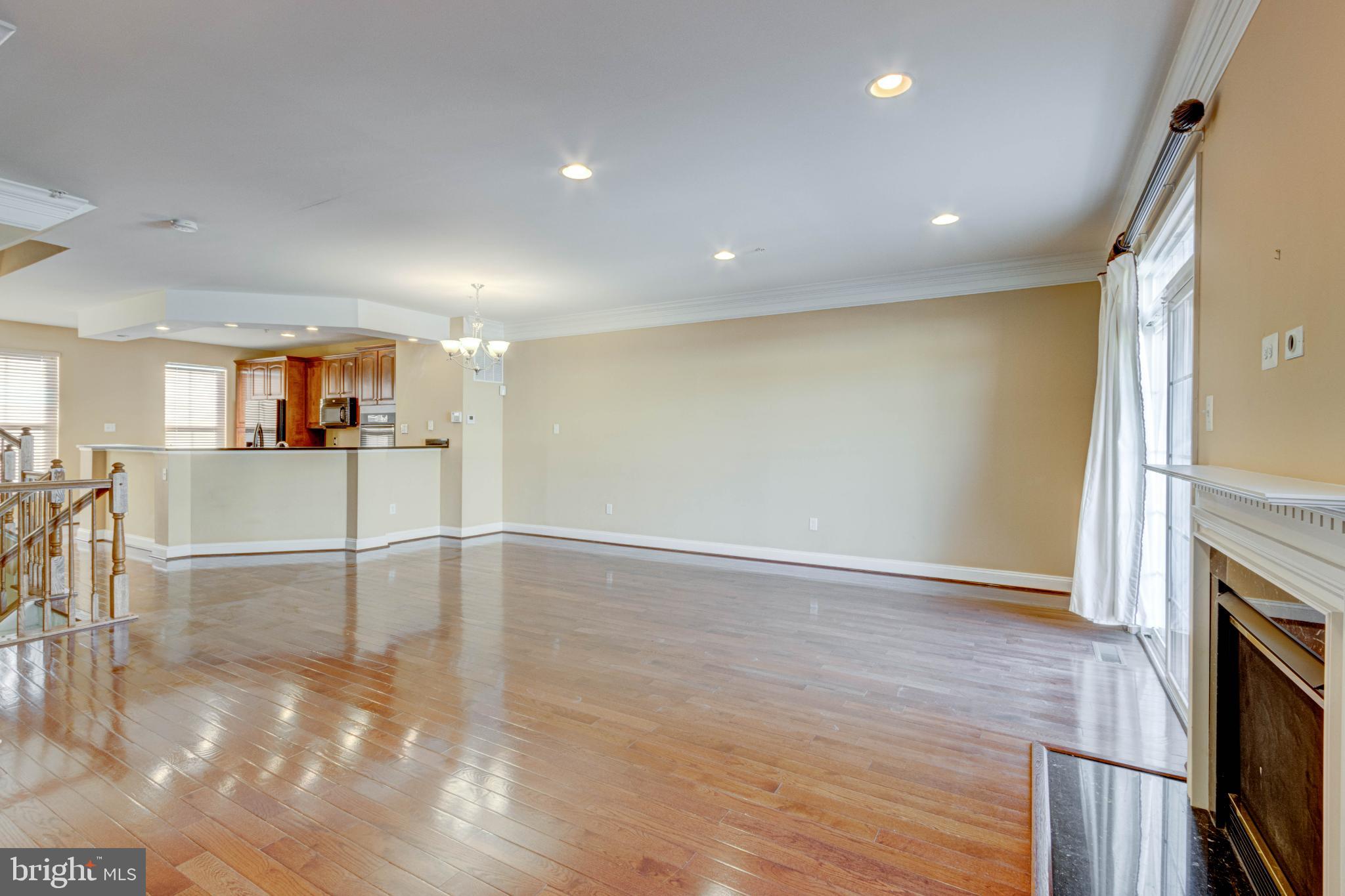2629 Raptor Drive Odenton, MD 21113 - Photo 7 of 20 an empty room with wooden floor and fireplace