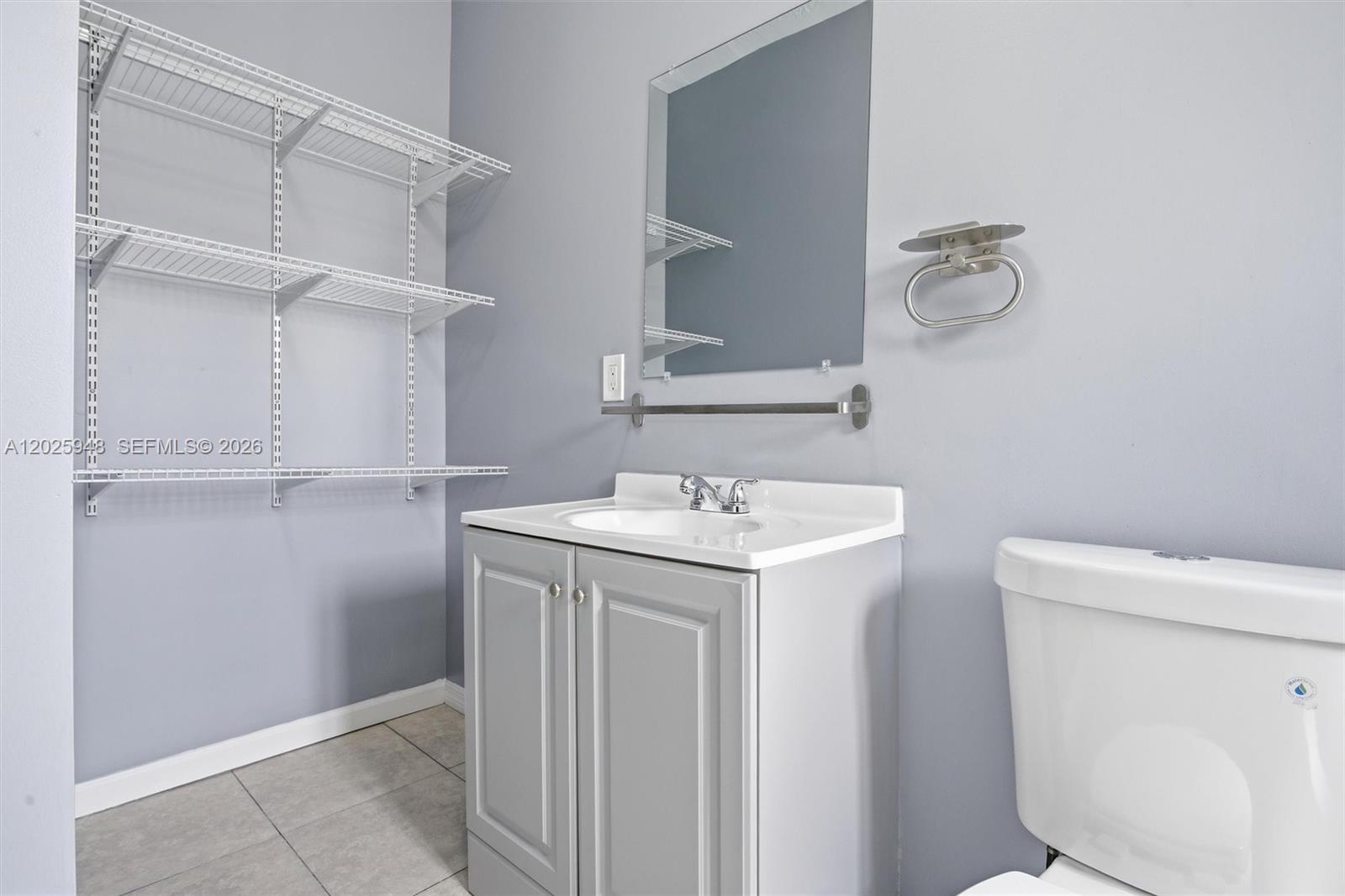 1745 Southwest 17th Street, Unit 2 Miami, FL 33145 - Photo 22 of 32 a bathroom with a sink a toilet and a mirror